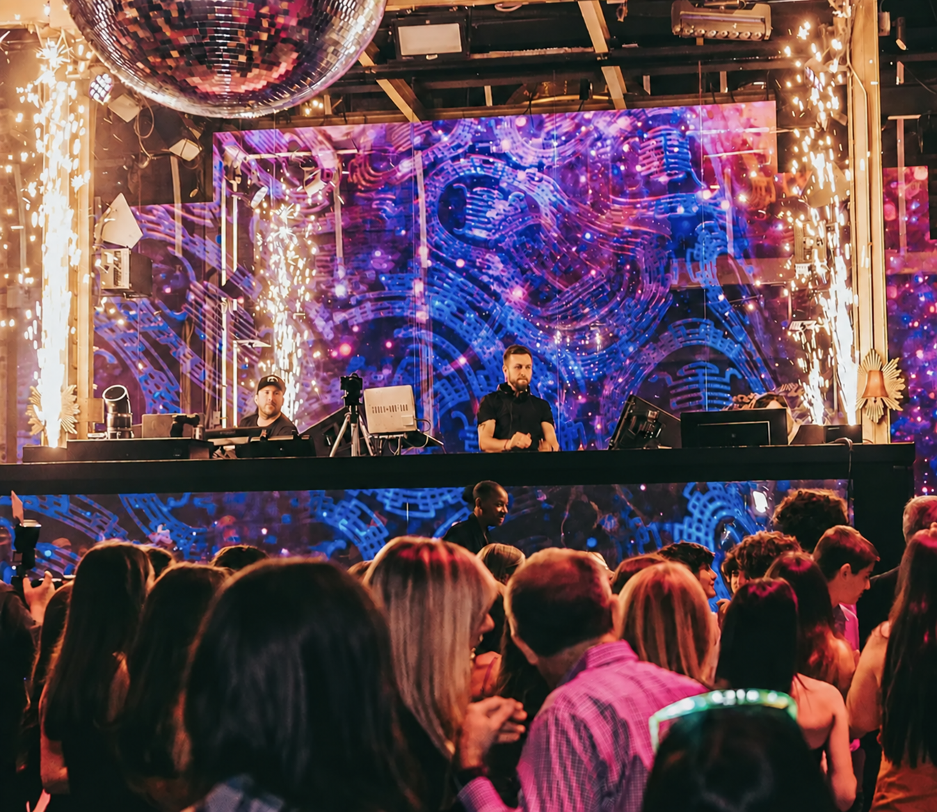 Chris England performing at TAO beneath blue and violet stage lights
